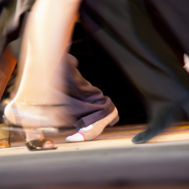 Dance moves and motion on salsa class. Milonga dance club - dancers performing an Argentinian tango.